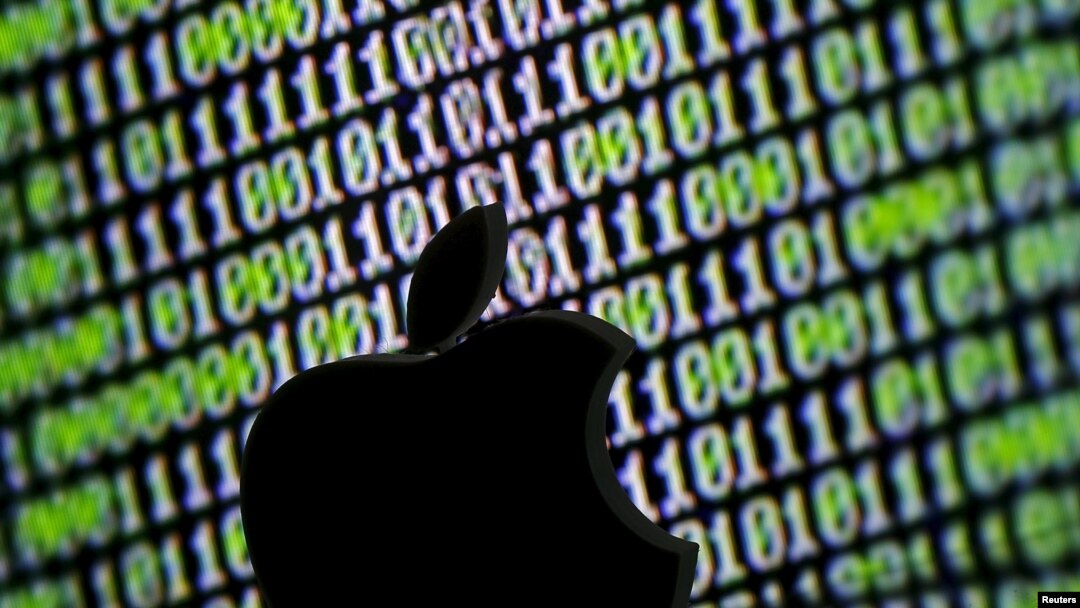 FILE - A 3D printed Apple logo is seen in front of a displayed cyber code in this illustration taken March 22, 2016. 