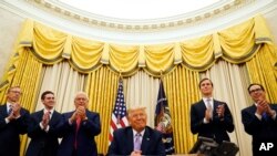 President Donald Trump is applauded after speaking in the Oval Office at the White House, Thursday, Aug. 13, 2020, in Washington. Trump said on Thursday that the United Arab Emirates and Israel have agreed to establish full diplomatic ties as part…