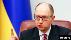 FILE - Ukraine's Prime Minister Arseny Yatseniuk speaks during a government meeting in Kyiv, Dec. 3, 2014. 
