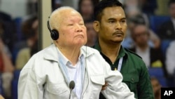 FILE - In this photo released by the Extraordinary Chambers in the Courts of Cambodia, Khieu Samphan, left, former Khmer Rouge head of state, appears in court during the U.N.-backed war crimes tribunal in Phnom Penh, Cambodia, November 16, 2018.