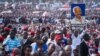 A man holds up a painted portrait of Edward Lowassa, former prime minister of Tanzania and presidential candidate for UKAWA, a coalition of four main opposition parties, during a political rally in Dar es Salaam, Tanzania, Aug. 29, 2015.