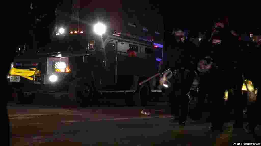 Officers in armored vehicles approach the Ferguson City Hall area where protesters were gathered, in Ferguson, Missouri, Nov. 25, 2014.