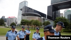 Police patrol outside the Legislative Council building in Hong Kong