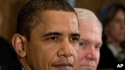 US President Barack Obama (L) sits alongside US Secretary of Defense Robert Gates during a Cabinet Meeting at the White House, 23 Nov 2009