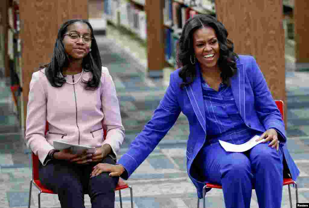 Former first lady Michelle Obama smiles as she begins her book tour with a stop at the Whitney M. Young Magnet High School in Chicago, Illinois, Nov. 12, 2018.