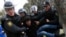 FILE - Police officers detain a man during a rally in Baku, Azerbaijan, Jan. 26, 2013. Azerbaijan has decided to give amnesty to over 400 people, including a number of political activists and journalists.