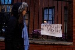 A pedestrian passes sign supporting the workers at Massachusetts General Hospital near the hospital amid the coronavirus disease outbreak in Boston, Massachusetts, United States, on April 3, 2020.