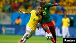 Neymar (gauche) se bat pour le ballon avec Allan Nyom du Cameroun lors de la Coupe du Monde 2014 dans le groupe A au stade national à Brasilia, 23 juin, 2014. REUTERS / Dominic Ebenbichler