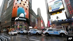 A row of New York City police cars is parked along a street in Times Square, Dec. 29, 2016, in New York.