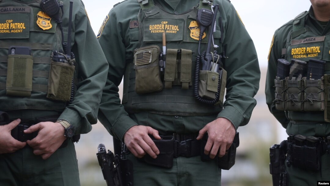 U.S. Border Patrol agents watch as President Donald Trump visits the banks of the Rio Grande River in Mission, Texas, Jan. 10, 2019. 