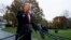 President Donald Trump talks with reporters before departing for France on the South Lawn of the White House, Friday, Nov. 9, 20