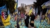 Women hold portraits of loved ones who were killed fighting amid Russia's invasion of Ukraine, at a memorial site for fallen Ukrainian soldiers as the country marks Defenders of Ukraine Day, in Kyiv, Oct. 1, 2024. 