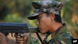  Kachin soldier mans a frontline position, facing off against Burmese government troops about 15 kilometers (9 miles) from the headquarters of the Kachin Independence Organization, in Laiza, Feb 13, 2012.