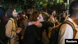 Two supporters of Greece's leftist Syriza party hug outside the party's headquarters, after a general election, in Athens, Greece, May 21, 2023.
