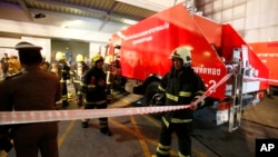 Emergency rescue and firefighting teams gather at the scene of a fire outside a mall complex in downtown Bangkok, Thailand, April 10, 2019. 
