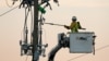 Crews work on power lines damaged by Hurricane Michael in Panama City Beach, Florida, Oct. 11, 2018. 