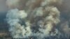 Aerial picture showing smoke billowing from a forest fire in the municipality of Candeias do Jamari in Rondonia State, on August 24, 2019.