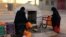 FILE - Moroccan women filling up containers with water from a hose, in Zagora, southeastern Morocco, Oct. 19, 2017. Experts blame poor choices in agriculture, growing populations and climate change for the water shortages in towns like Zagora. Moroccan state TV channel 2M reports that at least 15 people have died and 5 others have been injured in a stampede on Nov. 19, 2017 as food aid was being distributed in the village of Sidi Boulalam. 