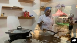 Chef Failatu Abdul-Razak attempts to break a world record for marathon cooking in Tamale, northern Ghana on Friday Jan. 5, 2024.