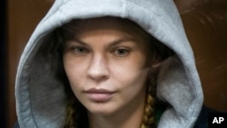 Anastasia Vashukevich, also known on social media as Nastya Rybka, sits in a cage in the court room in Moscow, Russia, Jan. 19, 2019.