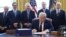 U.S. President Donald Trump signs the $2.2 trillion coronavirus aid package bill as Treasury Secretary Steven Mnuchin, Senate Majority Leader Mitch McConnell (R-KY), House Minority Leader Kevin McCarthy (R-CA) and Vice President Mike Pence stand by during a signing ceremony in th