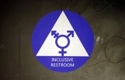 FILE - In this May 17, 2016, photo, a sticker designates a gender neutral bathroom at Nathan Hale high school in Seattle in Washington state.