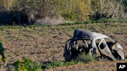 The wreckage of the car of investigative journalist Daphne Galizia lies next to a road in the town of Mosta, Malta. A car bomb killed the investigative journalist Oct. 16, 2017. 