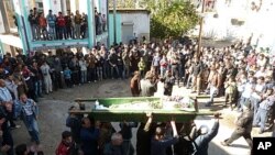 Anti-government protesters carry the coffin of Abdul Haleem Baqour during his funeral in Hula near Homs, Syria, December 10, 2011. Baqour was killed by shrapnel during shelling by the government army on Hula last week.