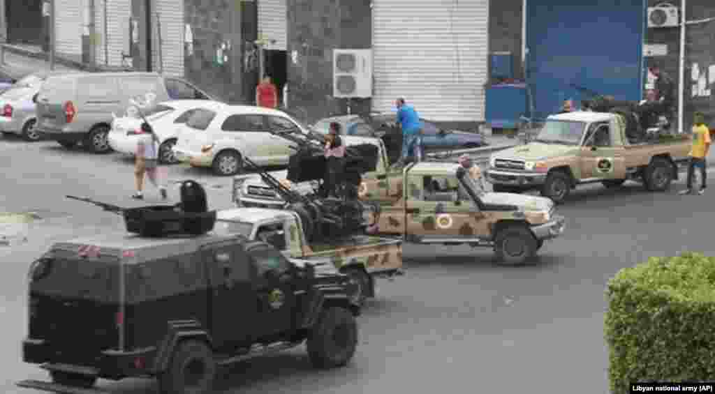 Tripoli joint security forces stand guard on the road to the parliament area after troops of Gen. Khalifa Hifter targeted Islamist lawmakers and officials at the parliament in Tripoli, Libya, May 18, 2014.