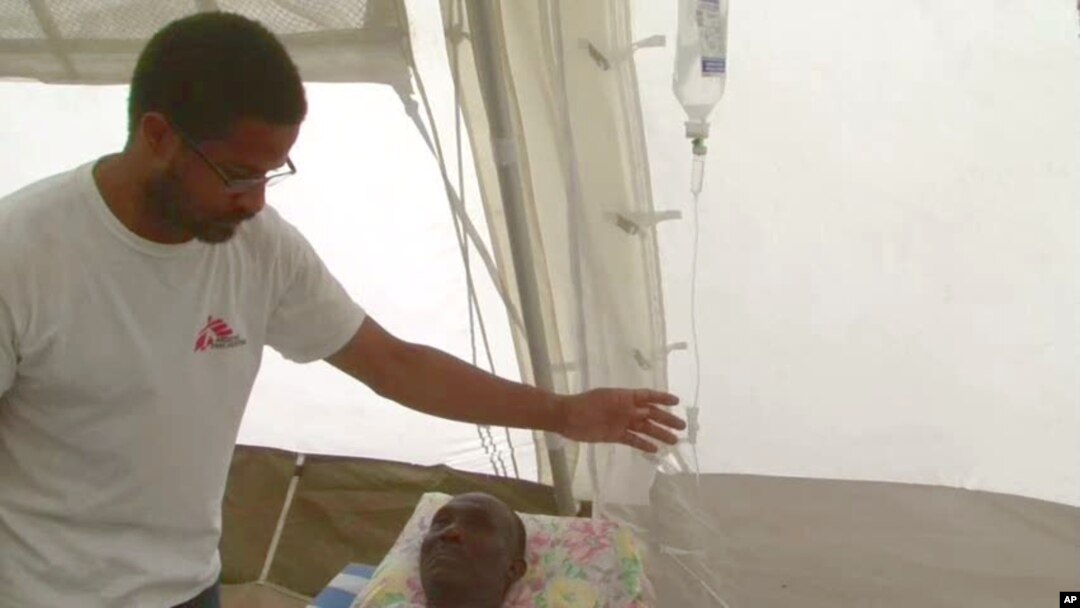 Nigerian-born Dr. Chibuzo Okonta with Doctors Without Borders attends to a patient in Port-au-Prince