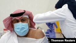 A Saudi man gets a dose of a coronavirus disease (COVID-19) vaccine, in Riyadh, Saudi Arabia Dec. 17, 2020.