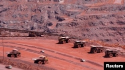 FILE— Haul trucks are seen at Kumba Iron Ore, the world's largest iron ore mines in Khathu, Northern Cape Province, Nov. 15, 2011. 