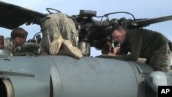 US Air Force crews prepare their helicopters at Bagram Air Base