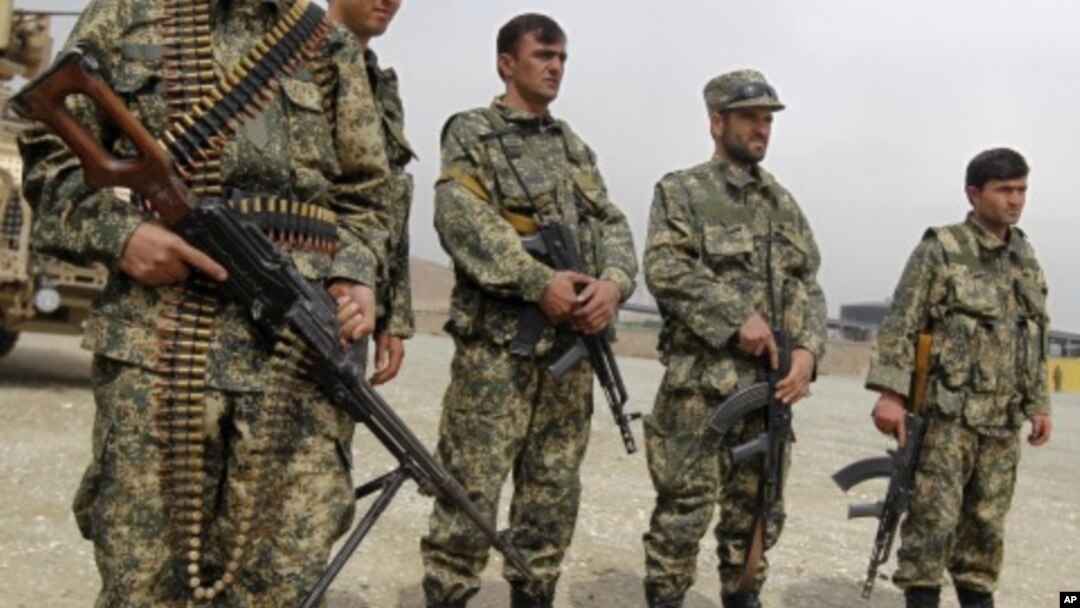 Afghan forces stand guard during a security transition ceremony from private security companies to the Afghan government in Kabul, March 15, 2012.