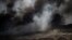 An oil worker walks next to burning oil fields in Qayara, south of Mosul, Iraq, Tuesday, Nov. 22, 2016.  
