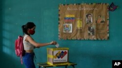 Una electora emite su voto durante las elecciones para elegir a los miembros de la Asamblea Nacional en Caracas, Venezuela, el domingo 6 de diciembre de 2020.