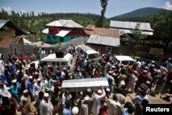 People carry the body of Ghulam Hassan Wagay, a policeman who according to local media was killed in a militant attack in south Kashmir's Pulwama district on Monday night, during his funeral at Wohlutra village in north Kashmir's Baramulla district, June 12, 2018.
