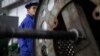 지난 5월 북한 '평양 326 전선공장'에서 한 노동자가 녹슨 생산 설비 너머를 바라보고 있다. (자료사진)
