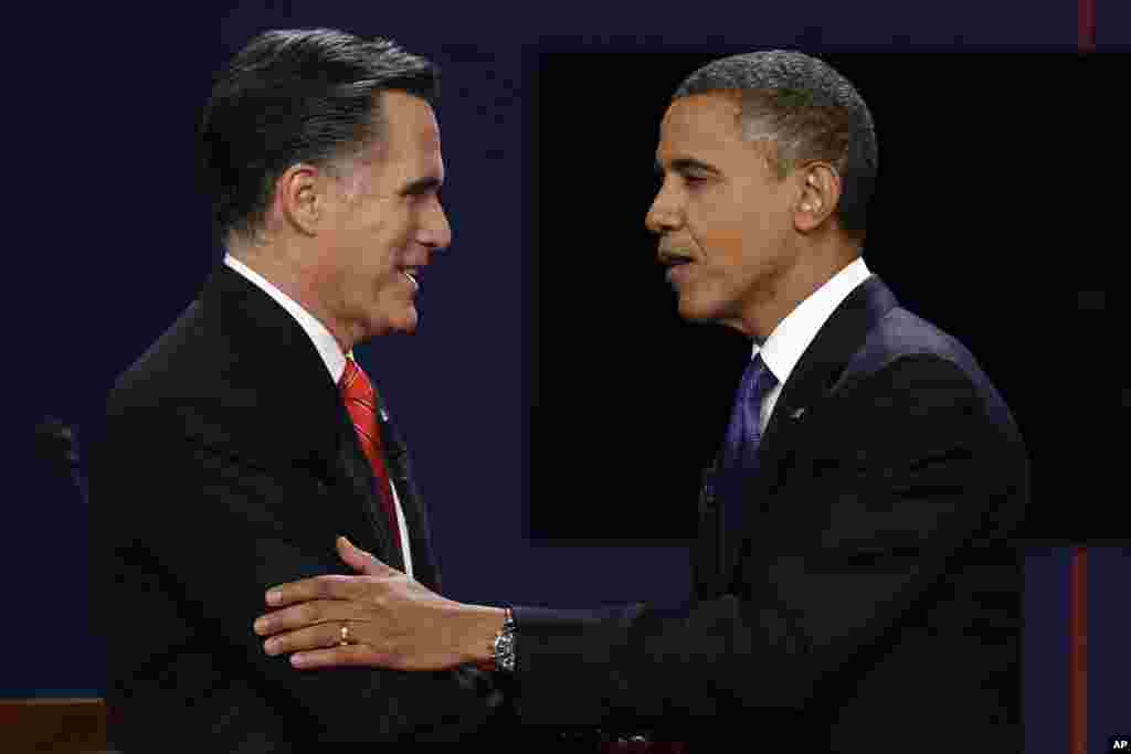 Mitt Romney (kiri) dan Presiden Barack Obama berjabat tangan setelah usainya debat di Denver (3/10).