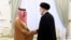 FILE - Saudi Arabian Foreign Minister Prince Faisal bin Farhan shakes hands with Iranian President Ebrahim Raisi in Tehran on June 17, 2023. Iran removed visa requirements for Saudi visitors, among others, on Dec. 14. (Office of the Iranian Presidency via AP)