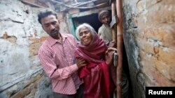 The brother, mother Ram Bai and father Mange Lal Singh (L-R) of Ram Singh, the driver of the bus in which a young woman was gang-raped and fatally injured three months ago, leave their house at Ravi Das camp in New Delhi, March 11, 2013. 