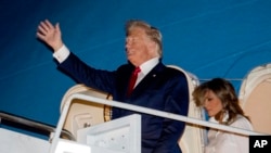 El presidente Donald Trump y la primera dama Melania Trump llegan al aeropuerto internacional de Palm Beach en West Palm Beach, Florida, el viernes 20 de diciembre de 2019. 