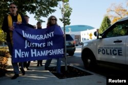 FILE - Demonstrators hold an "Interfaith Prayer Vigil for Immigrant Justice" outside the federal building in Manchester, New Hampshire, Oct. 13, 2017.