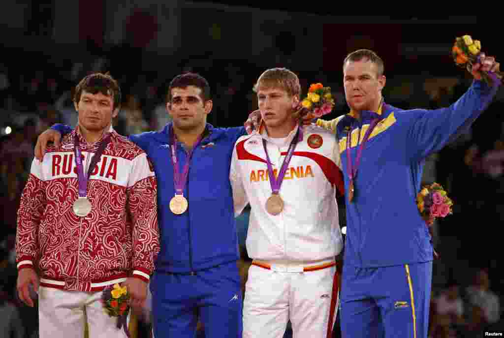 (L to R) Russia's Rustam Totrov, Iran's Ghasem Gholamreza Rezaei, Armenia's Artur Aleksanyan and Sweden's Jimmy Lidberg pose at the podium of the Men's 96Kg Greco-Roman wrestling at the ExCel venue during the London 2012 Olympic Games August 7, 2012. 