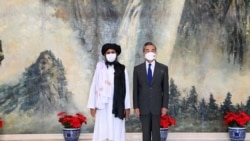 Chinese State Councilor and Foreign Minister Wang Yi meets with Mullah Abdul Ghani Baradar, political chief of Afghanistan's Taliban, in Tianjin, China, July 28, 2021.