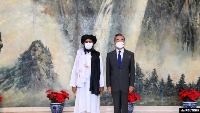 Chinese State Councilor and Foreign Minister Wang Yi meets with Mullah Abdul Ghani Baradar, political chief of Afghanistan's Taliban, in Tianjin, China, July 28, 2021.