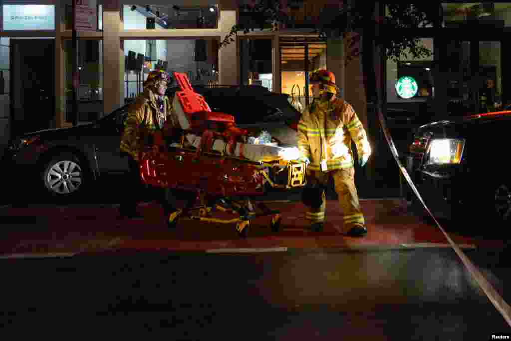 New York City firefighters use a wheeled stretcher to carry supplies near the site of an explosion in the Chelsea neighborhood of Manhattan, New York, Sept. 17, 2016.