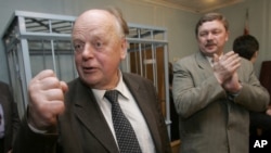 FILE - Former leader of Belarus and leading opposition activist Stanislav Shushkevich, left, gestures after his acquittal in a court room in Minsk, Belarus, May 12, 2006.