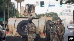 Members of California's National Guard patrol in Los Angeles, May 31, 2020, as the city begins cleaning up after a night of violence.