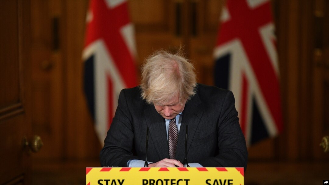 Britain's Prime Minister Boris Johnson reacts while leading a virtual press conference on the Covid-19 pandemic, inside 10 Downing Street Jan. 26, 2021, as official data shows that more than 100,000 people have died since the pandemic took hold last year.